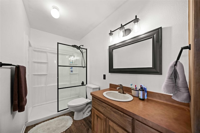 bathroom featuring hardwood / wood-style flooring, vanity, toilet, and walk in shower