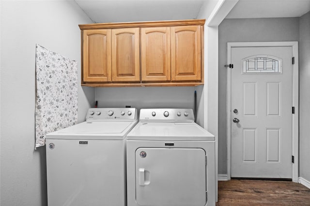 clothes washing area with cabinets, separate washer and dryer, and dark hardwood / wood-style floors