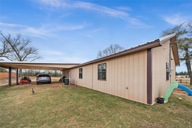 view of property exterior featuring a carport, a yard, and central air condition unit