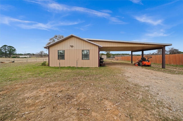 view of outdoor structure with a rural view and a carport