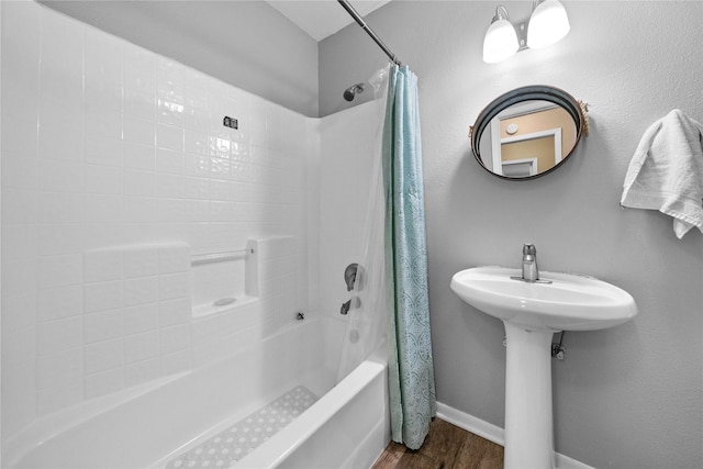 bathroom with shower / bath combo and hardwood / wood-style floors