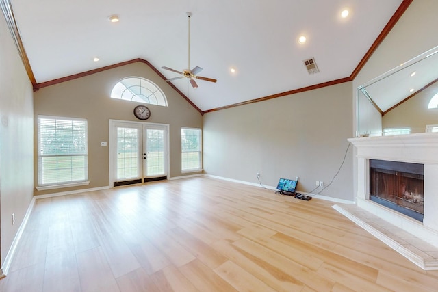 unfurnished living room with crown molding, ceiling fan, high vaulted ceiling, french doors, and light wood-type flooring