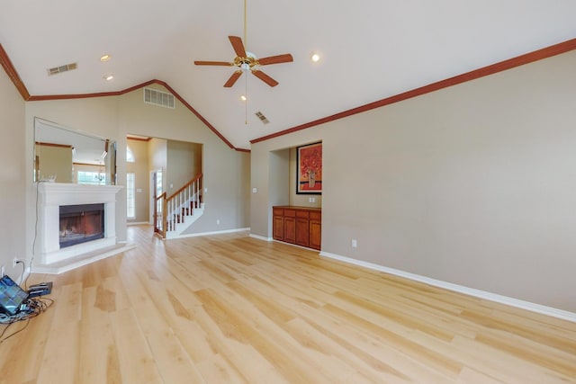 unfurnished living room with ceiling fan, light wood-type flooring, crown molding, and lofted ceiling