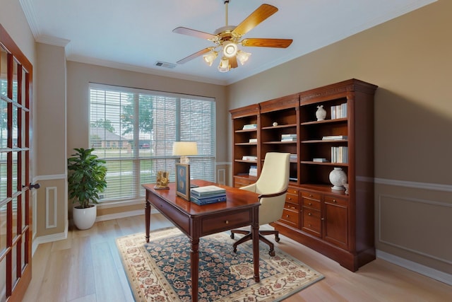 office space featuring ceiling fan, light wood-type flooring, and ornamental molding