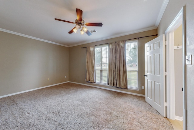 spare room featuring ceiling fan, ornamental molding, and light carpet