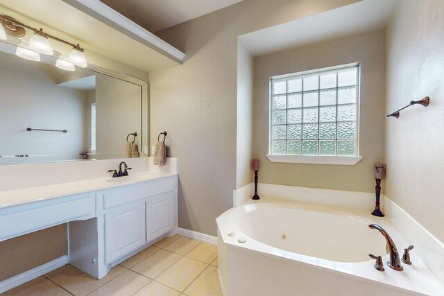 bathroom featuring a tub, tile patterned flooring, and vanity