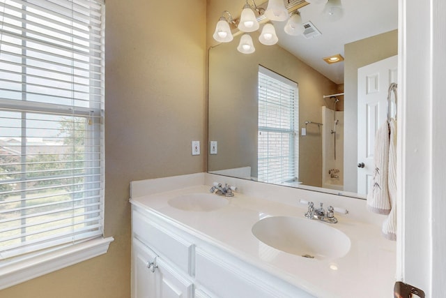 bathroom with vanity, tub / shower combination, and an inviting chandelier