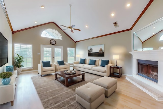 living room with ceiling fan, light hardwood / wood-style flooring, high vaulted ceiling, and french doors