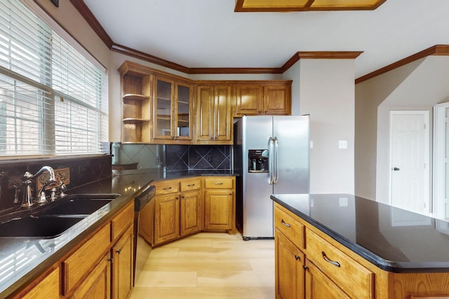 kitchen featuring sink, stainless steel fridge, black dishwasher, tasteful backsplash, and light hardwood / wood-style floors