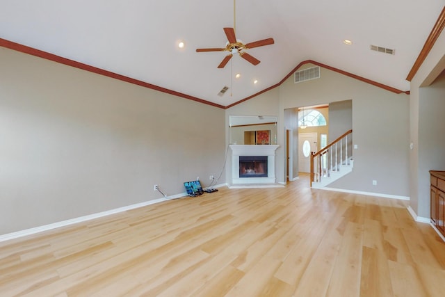 unfurnished living room with ornamental molding, lofted ceiling, ceiling fan, and light hardwood / wood-style floors