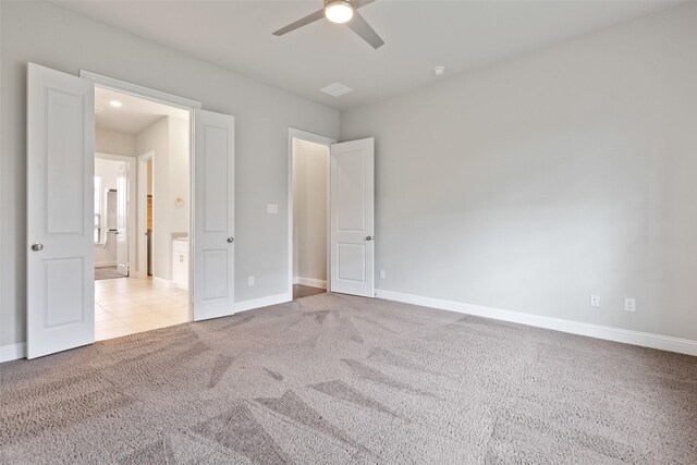 unfurnished bedroom featuring ceiling fan and light carpet