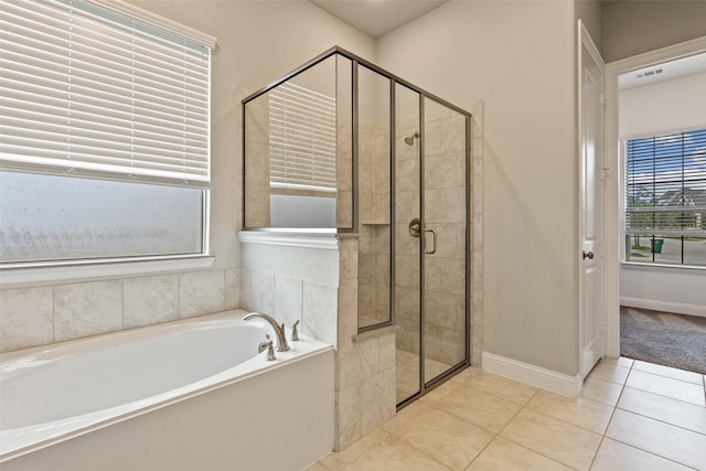 bathroom with tile patterned floors and separate shower and tub