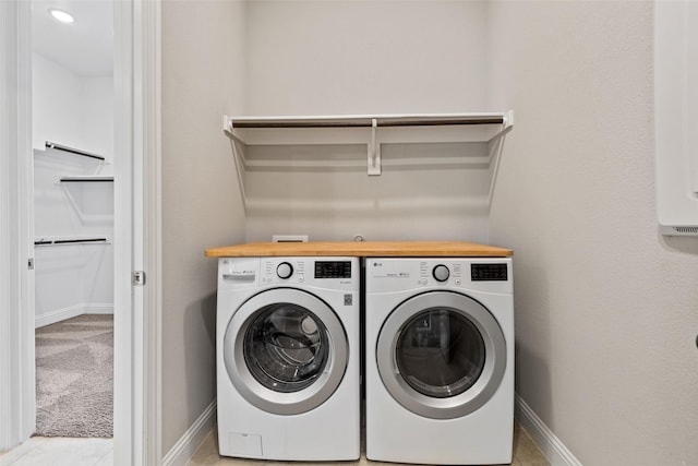 washroom featuring washing machine and dryer and light colored carpet