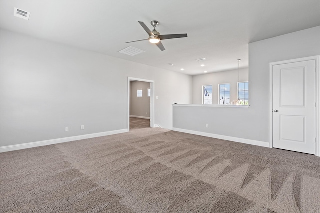 carpeted empty room featuring ceiling fan