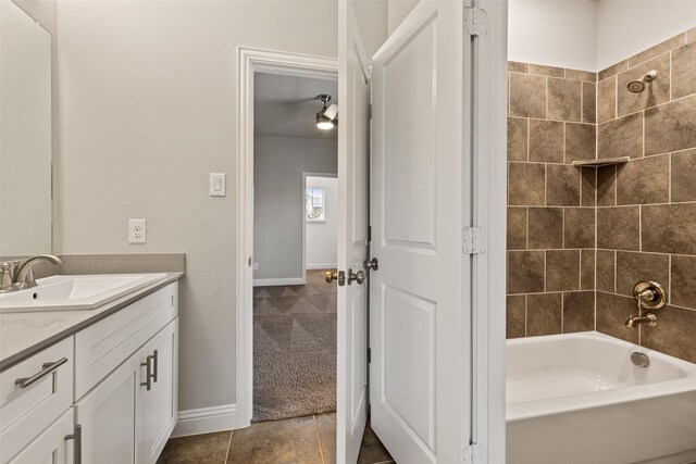 bathroom with vanity, tile patterned floors, and tiled shower / bath combo