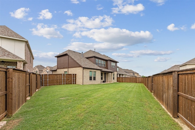 rear view of property with a yard