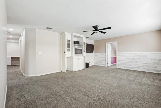 unfurnished room featuring dark hardwood / wood-style floors, ceiling fan, ornamental molding, and a tray ceiling