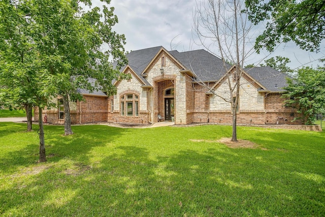 french country home with a front lawn