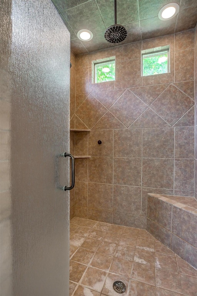 bathroom with a shower with shower door