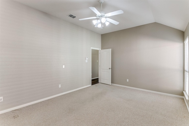 carpeted empty room featuring ceiling fan and lofted ceiling