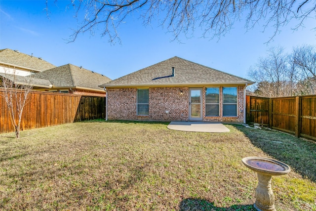 back of house featuring a patio area and a yard