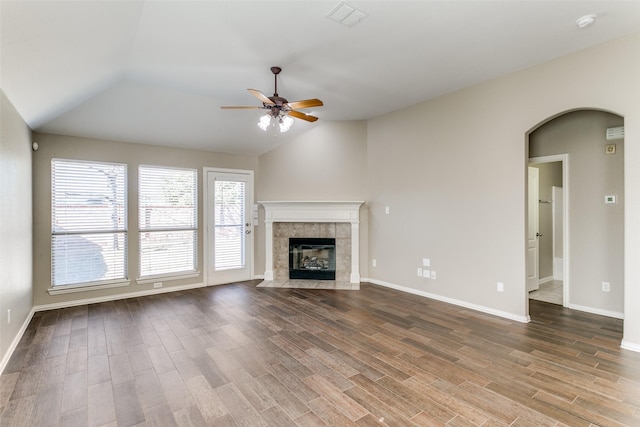 unfurnished living room with hardwood / wood-style floors, ceiling fan, lofted ceiling, and a fireplace