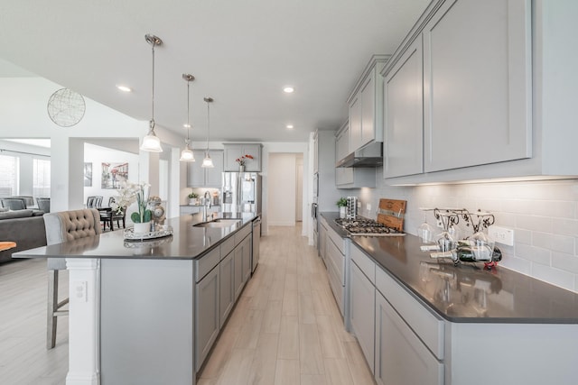 kitchen featuring a large island with sink, gray cabinetry, and sink