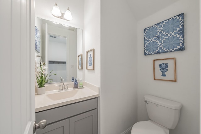 bathroom featuring vanity and toilet