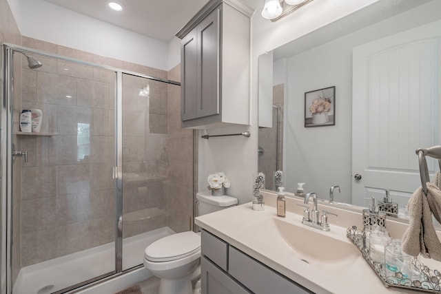 bathroom featuring vanity, toilet, and walk in shower