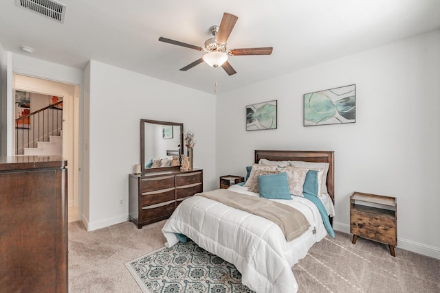 bedroom with light carpet and ceiling fan