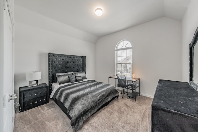 carpeted bedroom with lofted ceiling