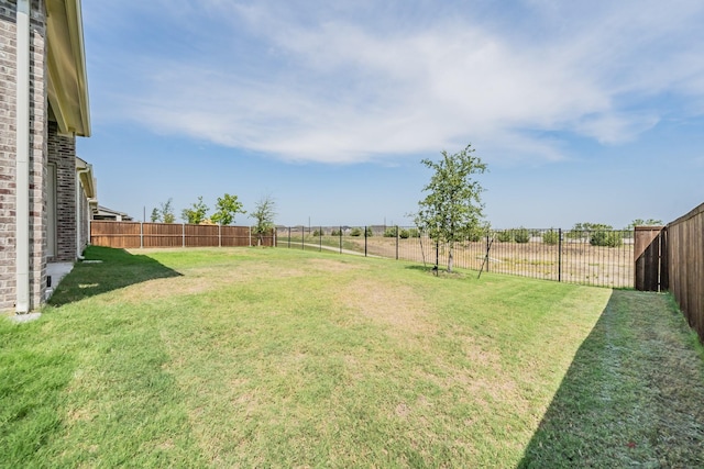 view of yard with a rural view