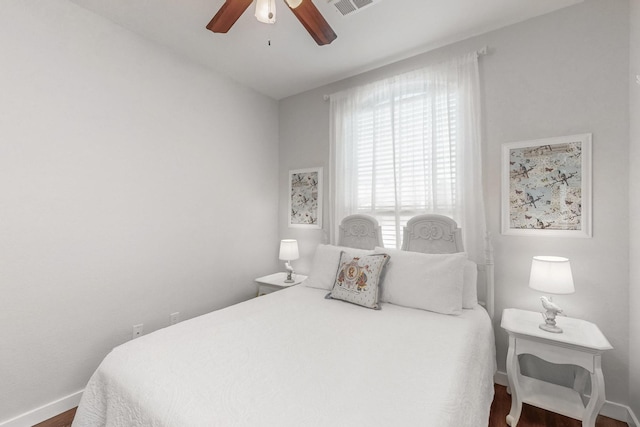 bedroom with ceiling fan and dark hardwood / wood-style floors