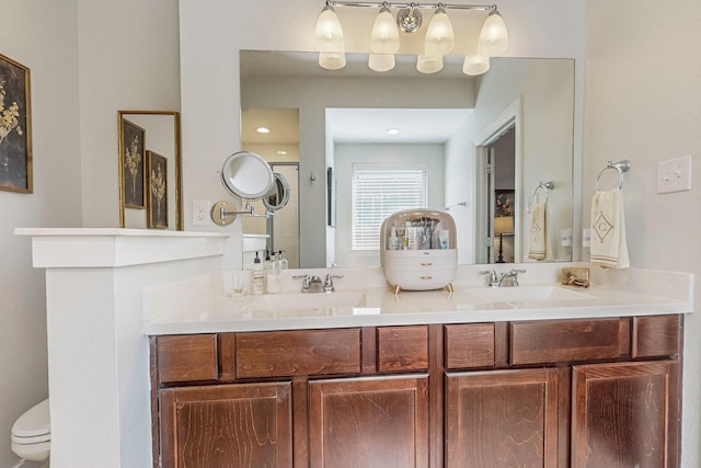 bathroom with walk in shower, vanity, and toilet