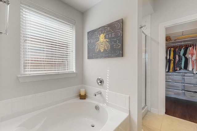 bathroom featuring tile patterned flooring and independent shower and bath