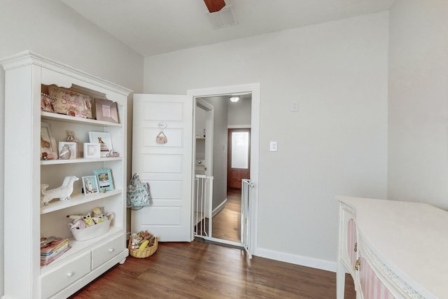 bedroom with ceiling fan and dark wood-type flooring