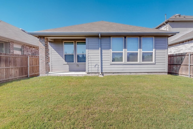 rear view of house with a yard