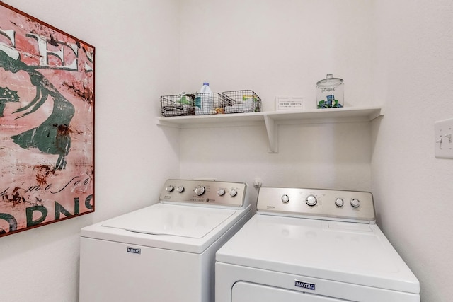 clothes washing area featuring washer and dryer