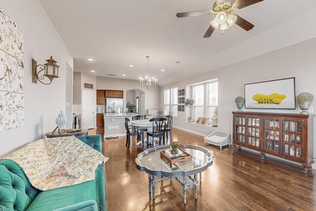 living room featuring sink, ceiling fan with notable chandelier, and dark hardwood / wood-style flooring