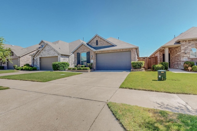 view of front of house featuring a garage and a front lawn