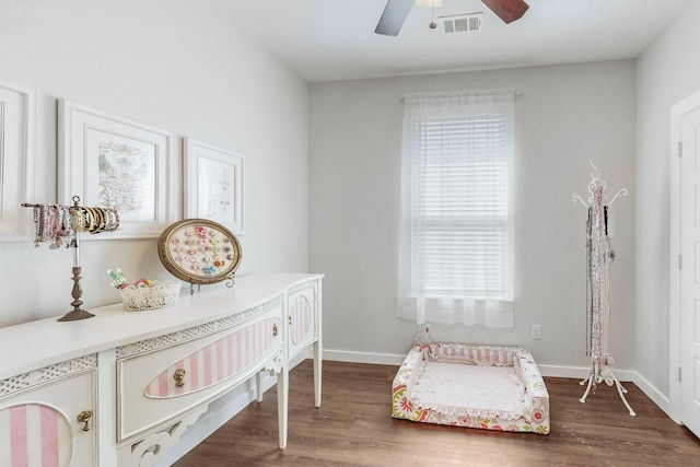 bedroom with dark hardwood / wood-style floors and ceiling fan