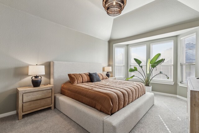 bedroom with carpet and vaulted ceiling