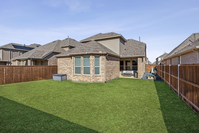 rear view of house with a lawn