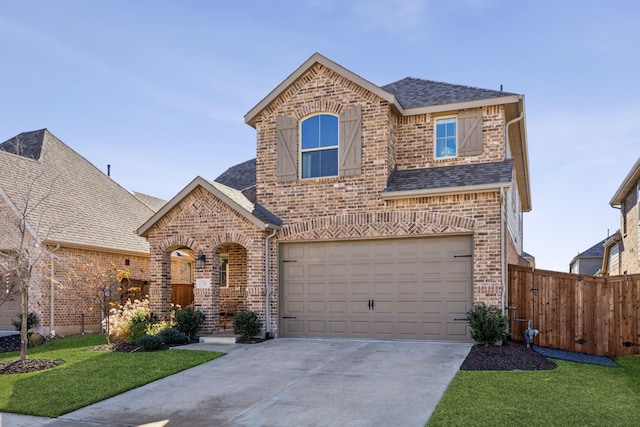 view of front of house with a garage and a front yard