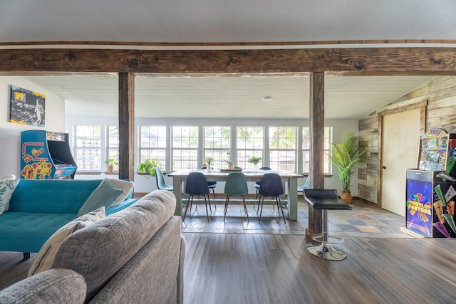 living room featuring hardwood / wood-style floors and vaulted ceiling with beams