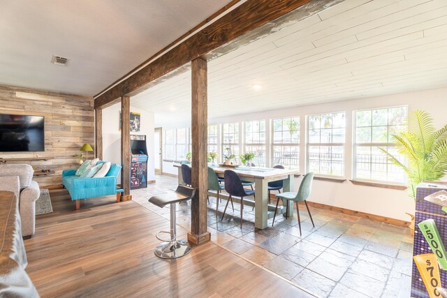 dining area featuring wooden walls