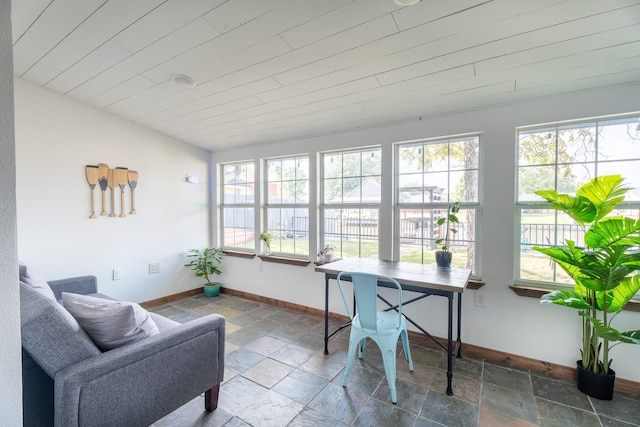 sunroom / solarium featuring a wealth of natural light and wood ceiling