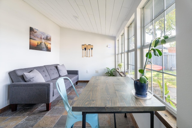 sunroom / solarium featuring wood ceiling and vaulted ceiling