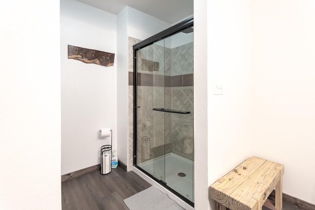 bathroom featuring hardwood / wood-style floors and an enclosed shower