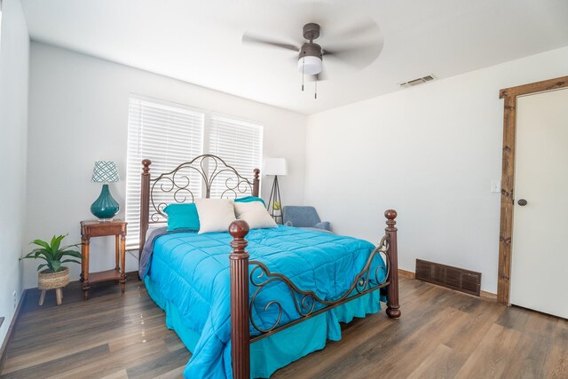 bedroom with ceiling fan and dark wood-type flooring